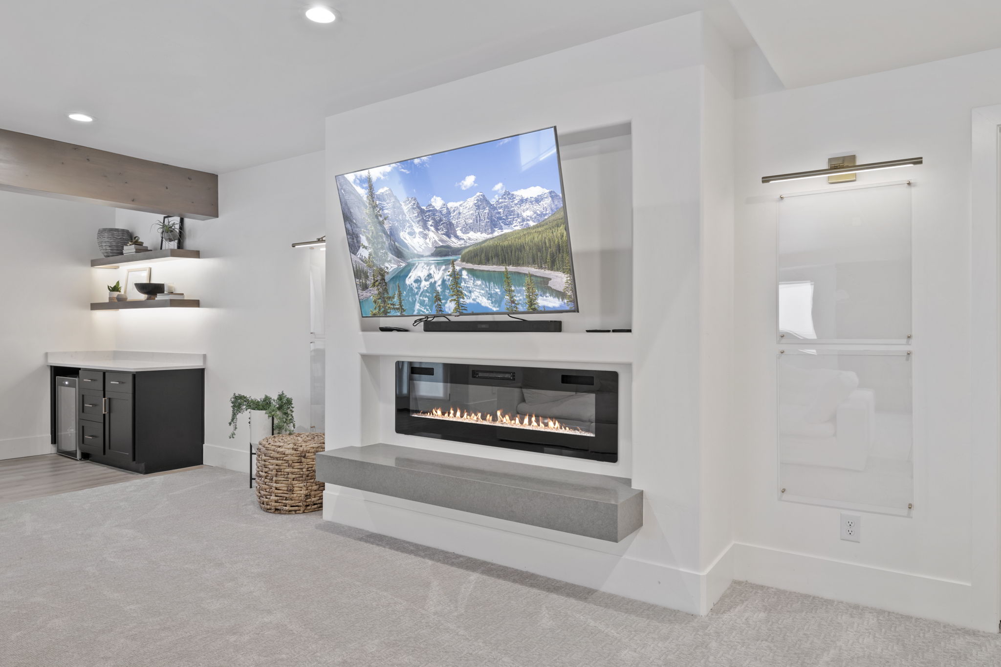 Basement kitchenette with electric fireplace and wet bar
